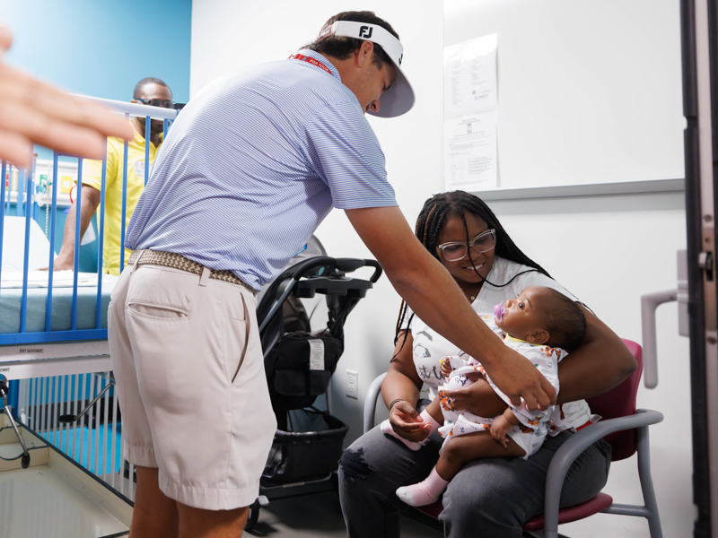 Sanderson Farms Championship golfer Cody Gribble visits with Children's of Mississippi patient Javeah Young of Minter City and her mom, Alexis Wallace. Gribble won the tournament in 2016. Melanie Thortis/UMMC Photography